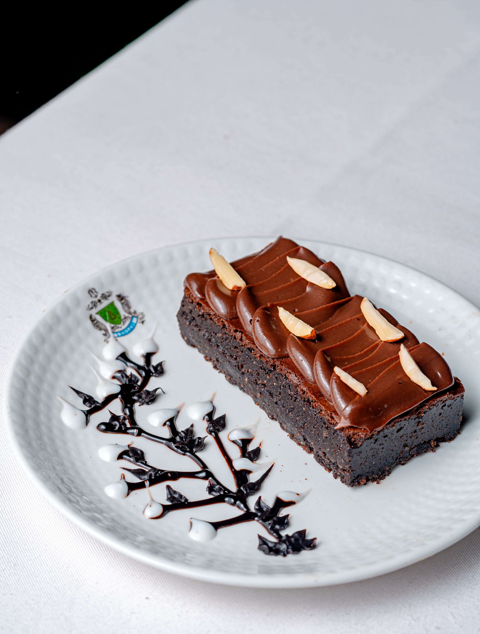 Almond brownie with chocolate glaze and flaked almonds