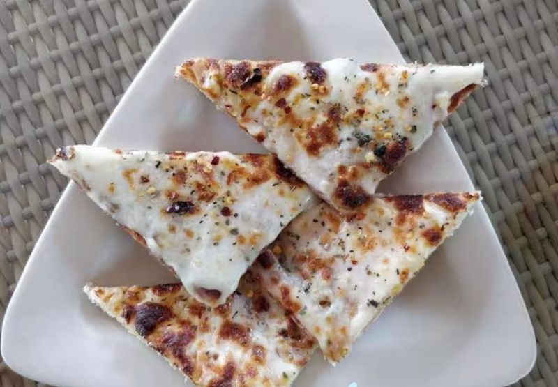 Cheesy garlic bread cut into triangles