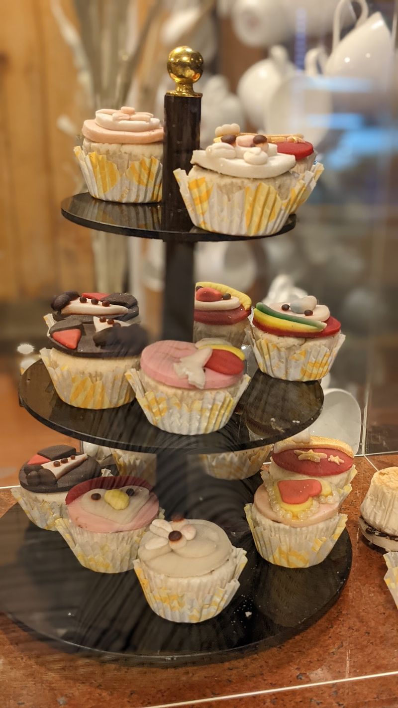 Cupcakes on a tiered stand in the glass counter