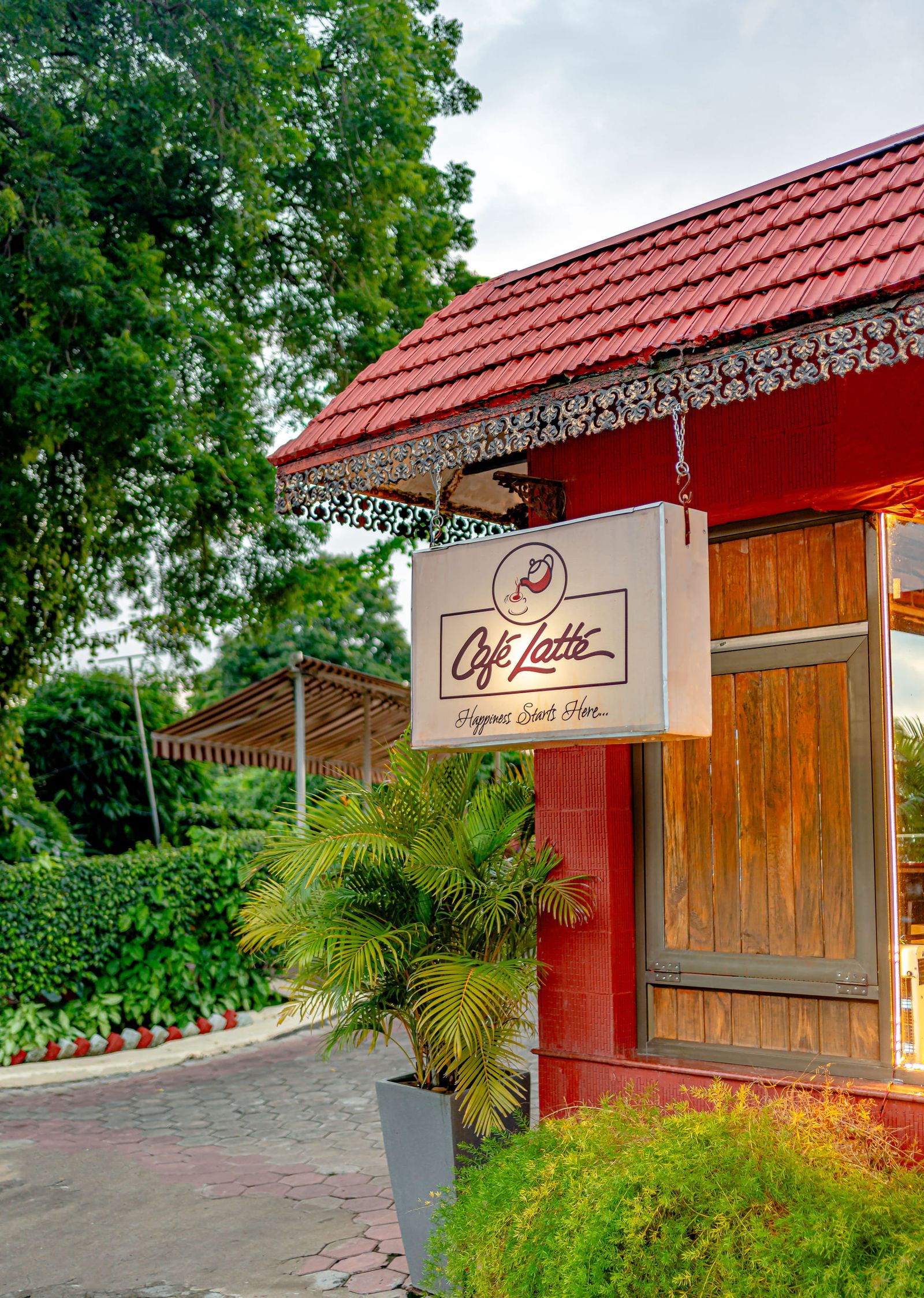The Café Latté sign hanging outside the red cottage